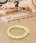 Nail Smooth Curves In Your Woodworking Projects With This Flexible Curve Router Guide Built Tough From Polyurethane And Equipped With Durable Brass Bushings Two Meters Long, displayed on a workbench with wooden planks.