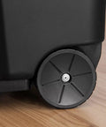Massive 169 Quart Big Ass Rolling Storage Tote Container With Rugged Heavy Duty Buckle Lid For Outdoor Camping Adventures Yard Cleanup And Home Organizing Black wheel detail on smooth caster for easy transport.