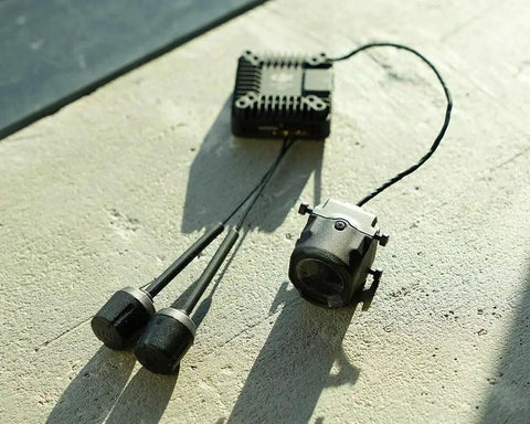 O4 Air Unit Pro FPV Drone Digital Transmission System with 15ms Latency, featuring compact components on concrete surface.