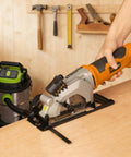 Extbtfor orange power circular saw with laser guide cutting wood on a workbench