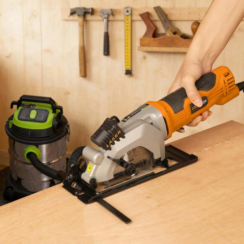 Extbtfor orange power circular saw with laser guide cutting wood on a workbench