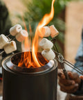 Mesa Outdoor Fire Pit Accessory Pack With 4 Stainless Steel Mini Sticks used for roasting marshmallows over tabletop fire pit.