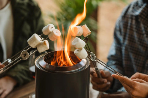 Mesa Outdoor Fire Pit Accessory Pack With 4 Stainless Steel Mini Sticks used for roasting marshmallows over tabletop fire pit.