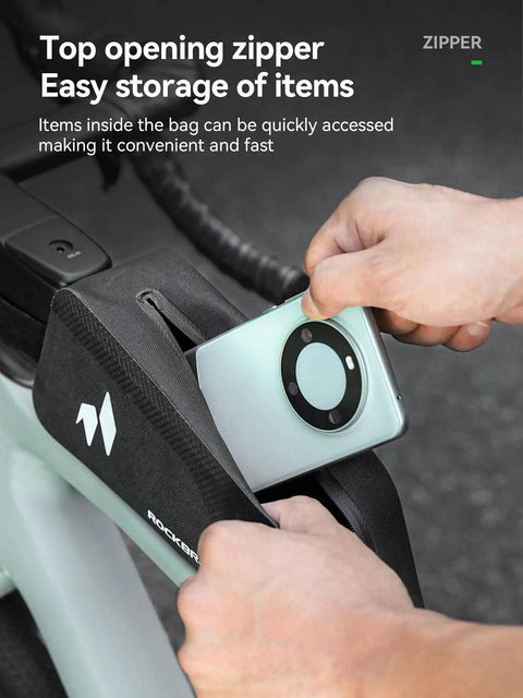 Person placing phone into Waterproof Top Tube Bike Frame Bag With Seamless One Piece Construction And Built In Support Plates