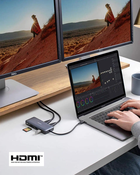 Person using laptop connected to Dual 4K USB C Docking Station for laptops with 2 HDMI ports, 8 in 1 hub, 85W power delivery.