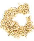 Gold metal grommets from Pro Grade Grommet Tool Kit for Tarps, Fabric, and Leather, heavy-duty metal retainer kit for quick binding.