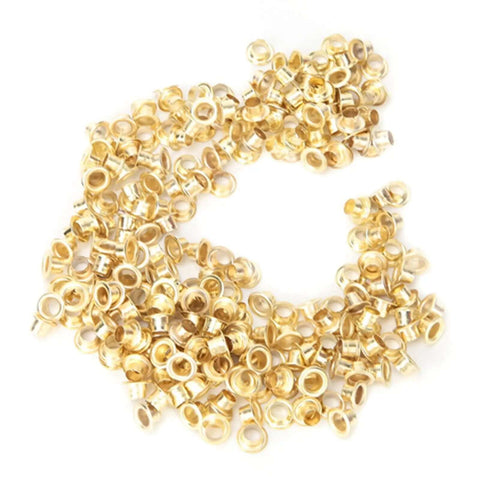Gold metal grommets from Pro Grade Grommet Tool Kit for Tarps, Fabric, and Leather, heavy-duty metal retainer kit for quick binding.