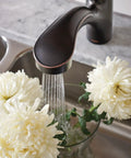 Brecklyn Mediterranean Bronze Single Handle Pull Out Sprayer Kitchen Faucet With Power Clean Tech washing white flowers