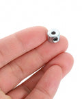 Hand holding One Eighth Inch Bore Three Eighth Inch Outside Diameter Two Pack Set Screw Shaft Collars Zinc Plated Carbon Steel
