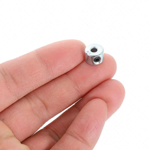Hand holding One Eighth Inch Bore Three Eighth Inch Outside Diameter Two Pack Set Screw Shaft Collars Zinc Plated Carbon Steel