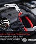 Hand holding electrical disconnect pliers from Five Piece Auto Wiring Harness And Fuel Line Repair Tool Kit for car maintenance