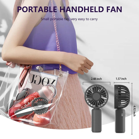 Woman carrying transparent bag with pink accessories and Four Pack USB Rechargeable Mini Handheld Fans Set With 3 Speeds.