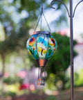 Hot Air Balloon Solar Lantern For Outdoor Use, Dragonfly Inspired Glass Hanging Light For Patio And Garden Decor, suspended in garden