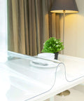 Clear Plastic Table Cover Protector for Tables and Desks, 36x72 Inches, 1.5mm Thick Vinyl Pad on white desk with plant