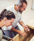 Two people using the 3 Pack Telescoping Measuring Stick Tap Measure Set With Long Extension Pole Reaching 94 Inches for woodworking.