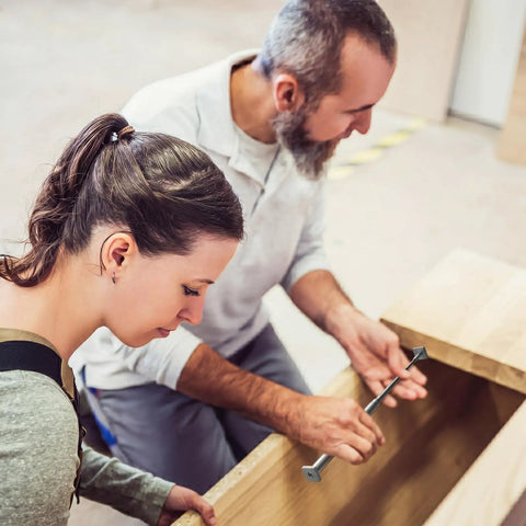 Two people using the 3 Pack Telescoping Measuring Stick Tap Measure Set With Long Extension Pole Reaching 94 Inches for woodworking.