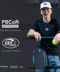 Person holding GX2 Hyper Pickleball Paddle With Aerodynamic Hyper Shape And SST 2.0 Carbon Core next to USA Pickleball Approved sign