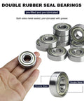 Hand holding one of the Ten Pack 6201-ZZ Double Metal Seal Deep Groove Ball Bearings, Pre-Lubricated For Smooth, Stable Performance.