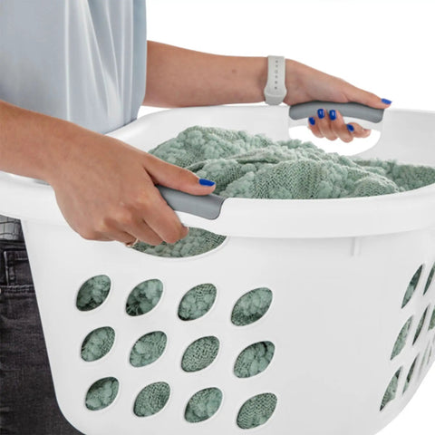 Person holding Six Pack HipHold Laundry Basket 1.25 Bushel White Contoured Plastic Hamper with Ventilated Holes and Comfort Grip