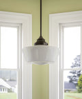 Cambridge 1 Light Pendant in Blackened Oil Rubbed Bronze With White Glass Shade between windows in dining room.