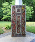Floral Carved Barn Wood Door 71x34 Inch Rustic Farmhouse Entry Pantry Door Double Or Single Sliding Door No Glass No Hardware Ideal For Headboard Wall Art Decor standing outdoors against greenery.