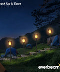 Solar Torch Light With Realistic Flickering Flame, Waterproof Outdoor Tiki Torches With 96 LED Bulbs Creating A Realistic Fire Look, No Wires Needed, Easy Setup, Durable Outdoor Lighting, 4 Pack installed on campsite at night