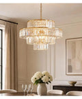 Luxury Gold K9 Crystal Chandelier Modern LED Pendant Light Energy Saving Lamp hanging above dining table with flowers.