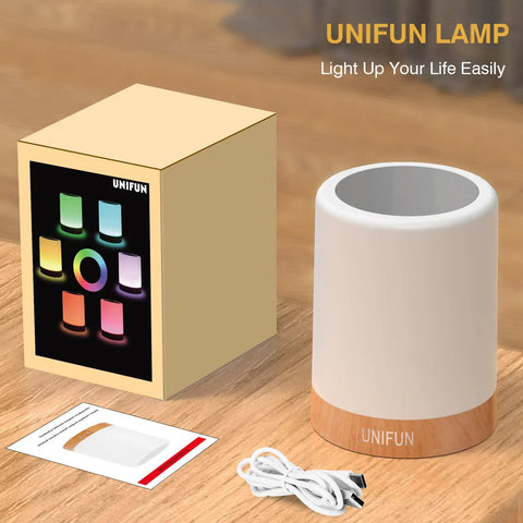 Touch Control Night Light Rechargeable Bedside Lamp With Dimmable Warm White 2800K 3100K And RGB Color Changing Portable Cordless LED Lamp with packaging on a table.