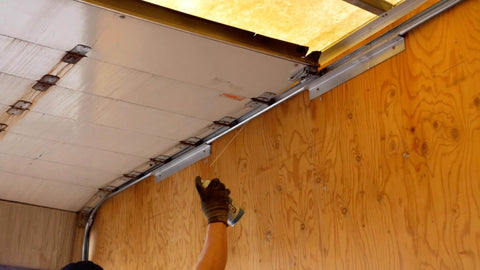 Applying Silicone Garage Door Lubricant Spray For Smoother Quieter Operation On Tracks Rollers And Hinges Will Not Attract Dust