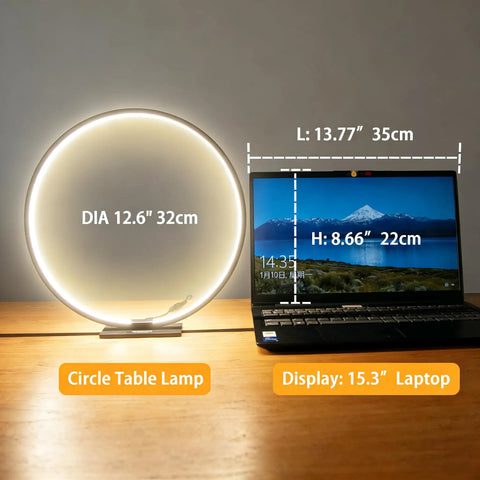 Open Circle LED Table Lamp With Dimmable Touch Control And Warm 3000K Light in Black next to laptop on wooden table