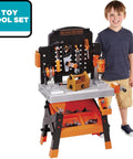 Kids Power Tools Workshop Bench With 75 Realistic Tools, Lights And Sounds, young boy standing next to toy workbench.
