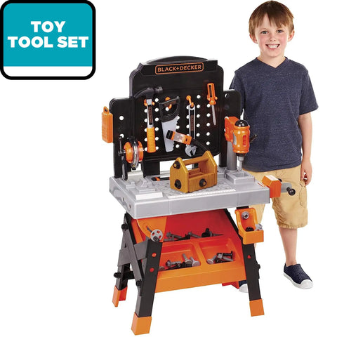 Kids Power Tools Workshop Bench With 75 Realistic Tools, Lights And Sounds, young boy standing next to toy workbench.