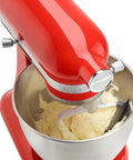 3.5 Quart Tilt-Head Flex Edge Beater With Nylon Coated Scraper in red stand mixer with batter