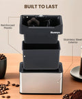 Automatic Portafilter Washer With Three Liter Tank Efficient Three Way Valve Rapid Drainage, black plastic and stainless steel design.