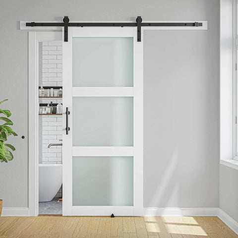 Front view of 38 X 84 Inch Three Lite Frosted Glass and Wood Paneled Barn Door With Installation Hardware Kit in modern interior.