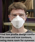 Person wearing Aura Particulate Respirator 9210 Plus N95 Disposable Mask Pack Of 20 For Dust And Smoke Keeps Eyewear From Fogging