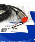 Autonics PR18-5DP Inductive Proximity Sensor M18 5mm Sensing Distance 12-24V DC 3-Wire PNP Output For Industrial Automation Rugged Heavy-Duty Build New 1 Piece, threaded metal body with cable