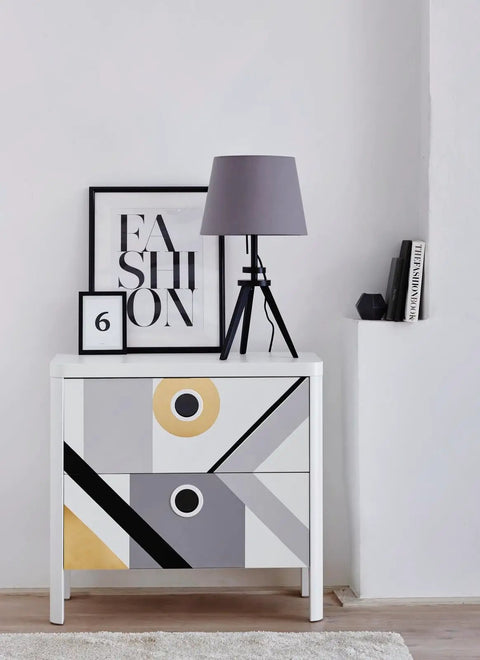Stylish modern dresser with abstract design in a room, featuring a lamp and artwork, showcasing home decor possibilities.