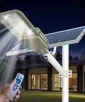 Powerful 1000W Solar Street Light Outdoor Waterproof IP67 Dusk To Dawn With Remote Control in operation outside a building.