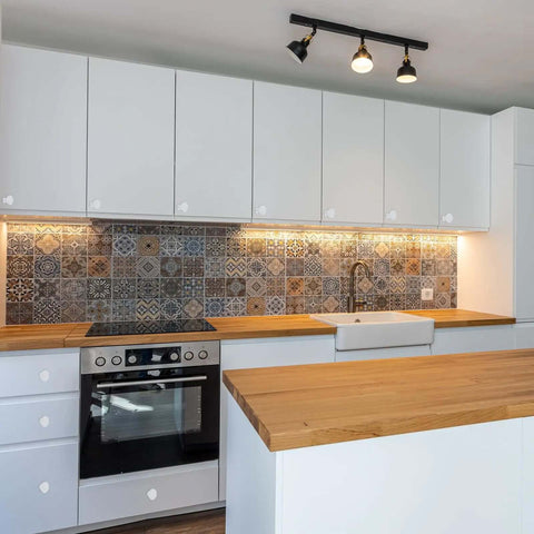 Modern kitchen with decorative tile backsplash, white cabinets, and wood countertop, showcasing Hella Vintage Floral Ceramic Cabinet Knobs.