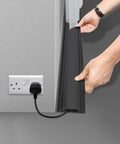 Person installing Heavy Duty PVC Floor Cord Cover For Wires And Cables, Easy Unroll Floor Cable Management Ramp, Black, on floor near outlet.