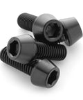 Close-up of four black titanium water bottle cage bolts with hex socket heads.