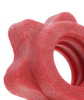 Close-up of red plastic anti skid barbell self locking nut from the four pack for home gym and weight lifting accessories.
