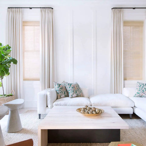 Bright living room with white couch, wooden coffee table, and tall windows showcasing potential backdrop for 15.7In By 16.4Ft Matte White Peel And Stick Wallpaper No Fuss Self Adhesive Contact Paper For Kitchen Countertops Cabinets And Wardrobes Thick Waterproof Repositionable Easy Install And Removable Without Damage.