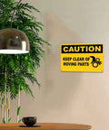 Caution Keep Clear Of Moving Parts 8 By 12 Inch Aluminum Sign on wall in indoor setting