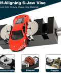 Beefy Heavy Duty Multi Material Workbench Vise With Universal Clamping for wood, plastic, metal, and irregular objects, holding a toy car.