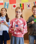 Children holding flags from World Flags Flashcards Set With 245 Countries, Geography Game With World Map showing USA, UK, Brazil.
