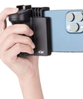 Hand holding Compact Phone Camera Grip Handle With Tripod Mount Remote Shutter And Cold Shoe Adapter attached to smartphone.