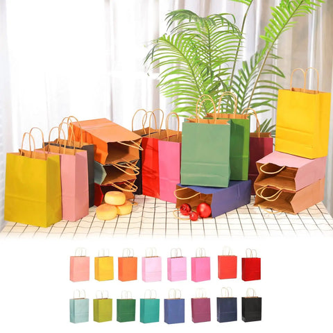 Medium Kraft Gift Bags With Handles, 16 Colorful Options, 10.6 x 8.3 x 4.3 Inches, assortment of 16-pack on display with plants