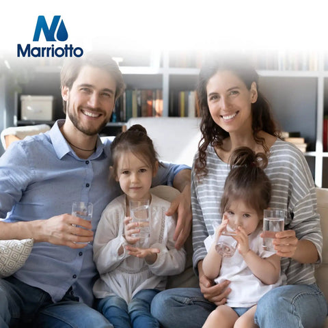 Family of four smiling, holding glasses of clean water, with Marrio water filter logo visible, representing purified drinking water.
